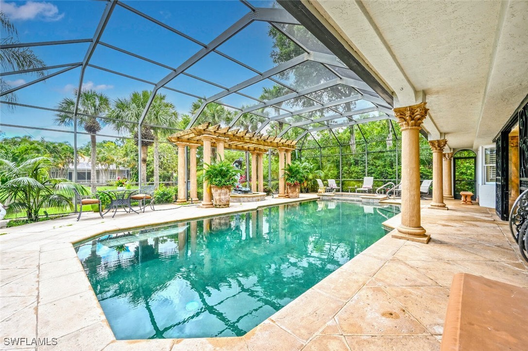 481 Crestwood Road Naples, FL 34113 - Photo 27 of 27 a view of a swimming pool with a patio