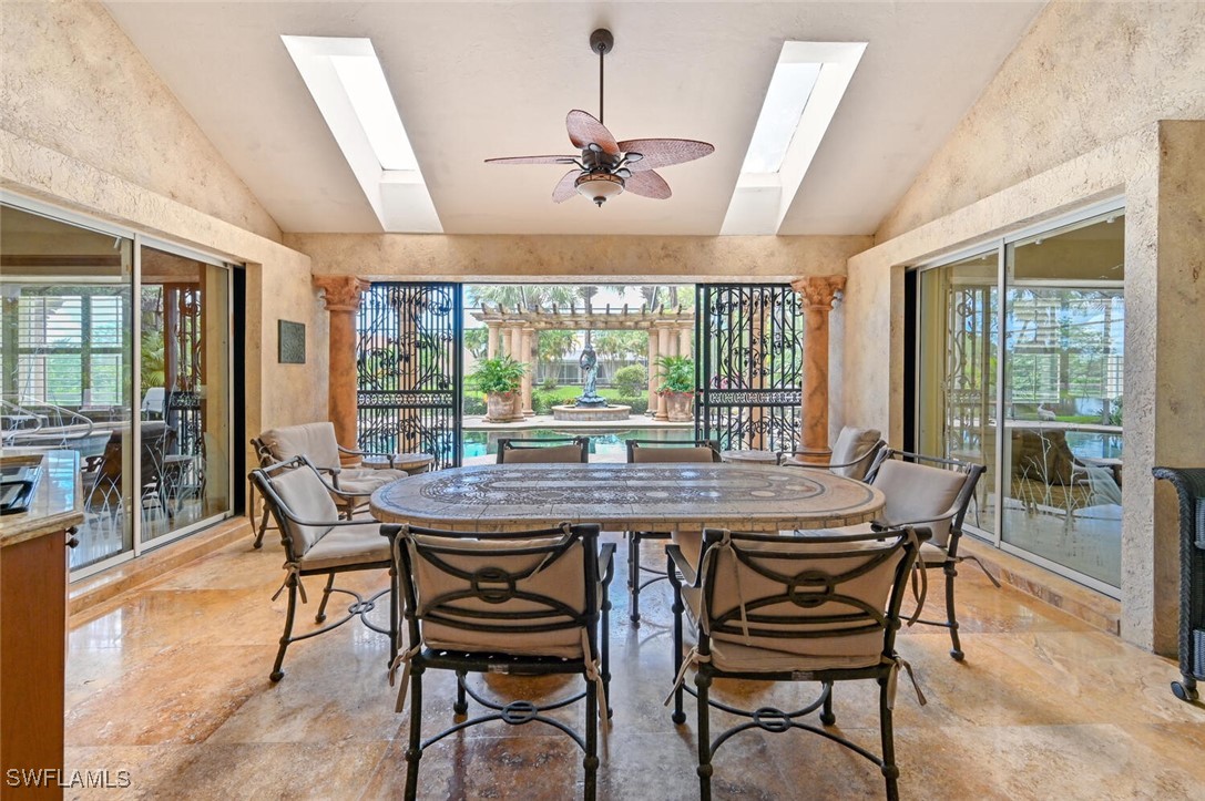 481 Crestwood Road Naples, FL 34113 - Photo 4 of 27 a dining room with furniture a chandelier and wooden floor