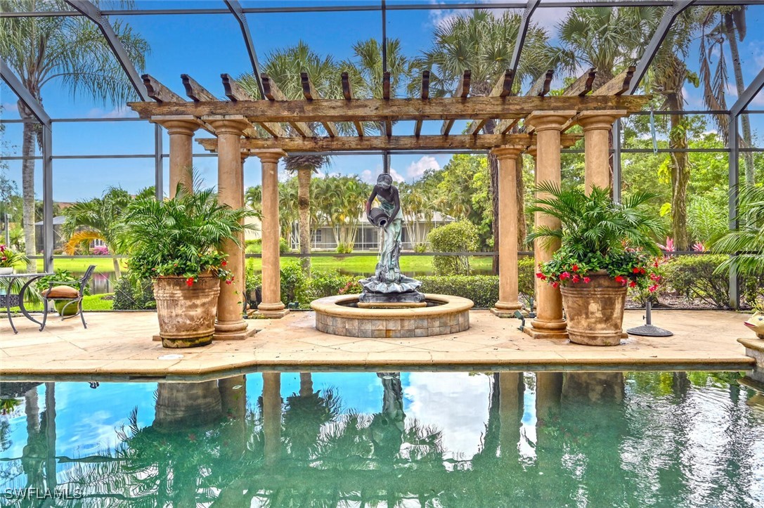 481 Crestwood Road Naples, FL 34113 - Photo 5 of 27 a view of a swimming pool with a patio
