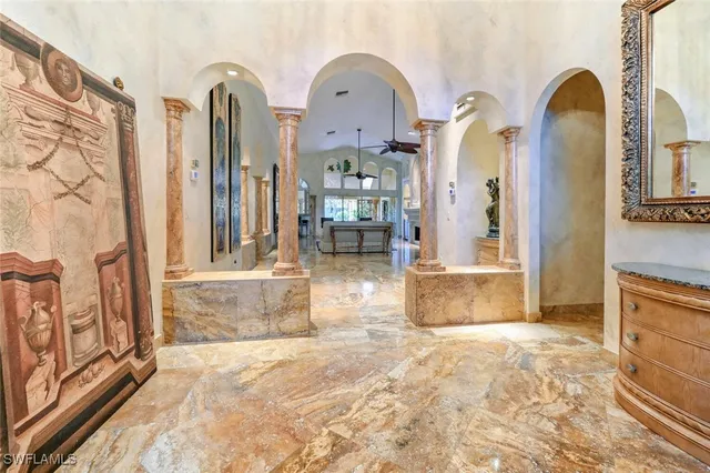 a large kitchen with granite countertop a sink and dishwasher a stove top oven with wooden floor