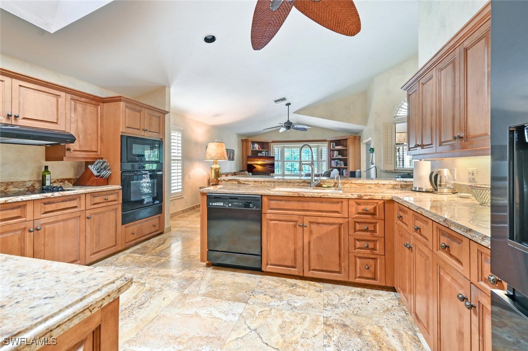 481 Crestwood Road Naples, FL 34113 - Photo 8 of 27 a large kitchen with granite countertop a sink and dishwasher a stove top oven with wooden floor