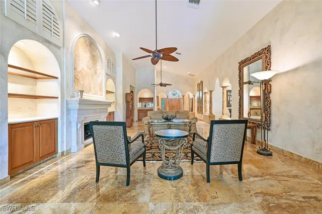 a living room with fireplace furniture and a chandelier