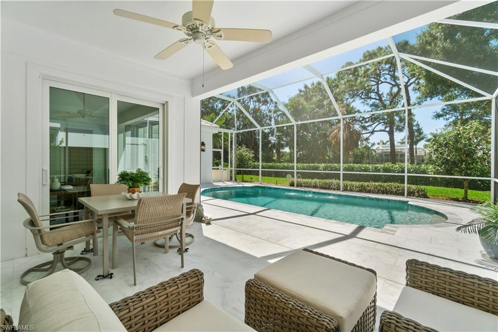 764 Ashburton Drive Naples, FL 34110 - Photo 15 of 30 a view of a patio with couches chairs and potted plants