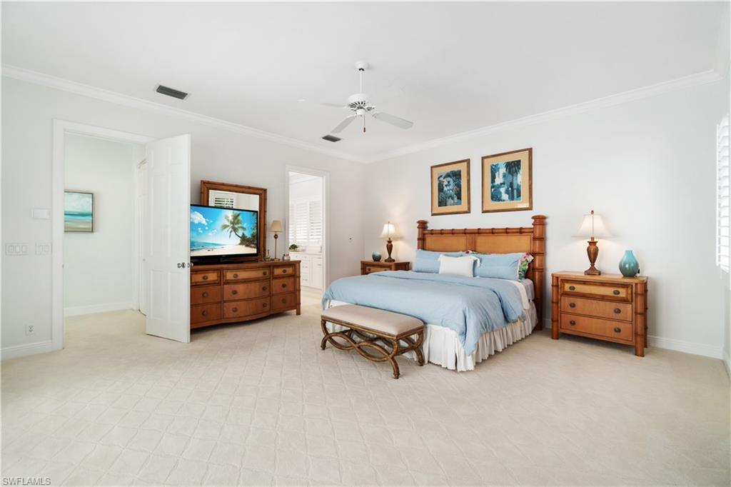 764 Ashburton Drive Naples, FL 34110 - Photo 18 of 30 a bedroom with furniture and a flat screen tv
