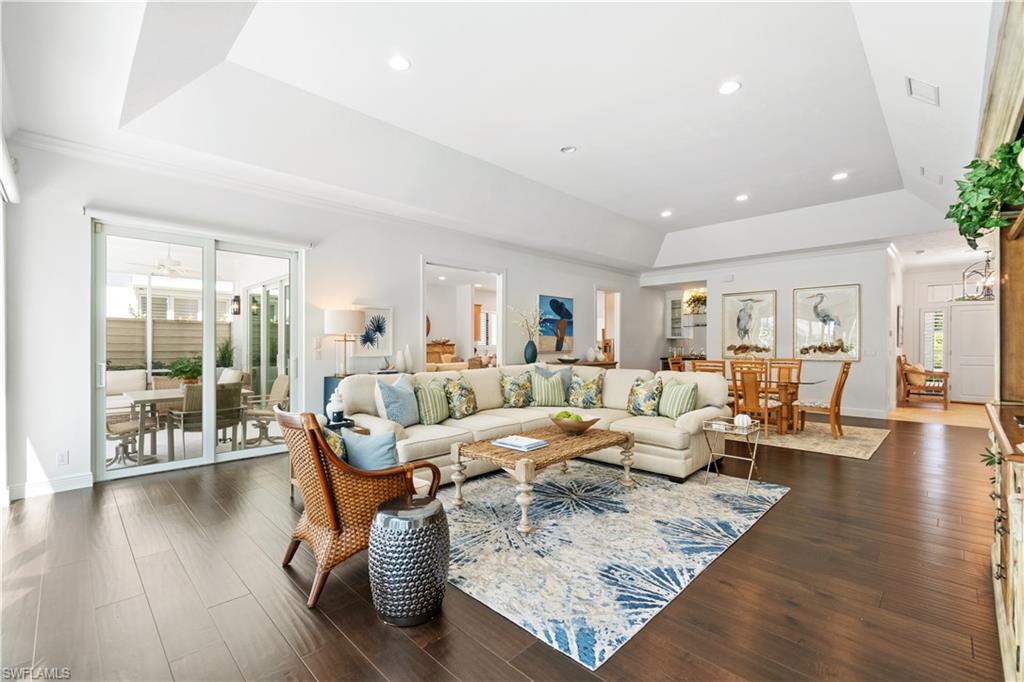 764 Ashburton Drive Naples, FL 34110 - Photo 2 of 30 a living room with furniture wooden floor and a table