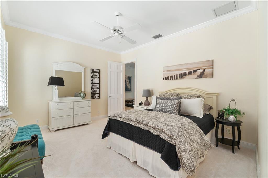 764 Ashburton Drive Naples, FL 34110 - Photo 21 of 30 a bedroom with a large bed and ceiling fan