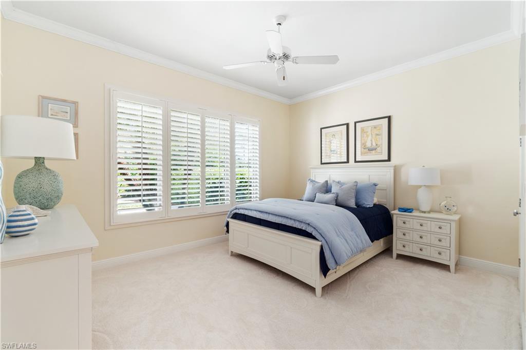 764 Ashburton Drive Naples, FL 34110 - Photo 24 of 30 a spacious bedroom with a bed and a window