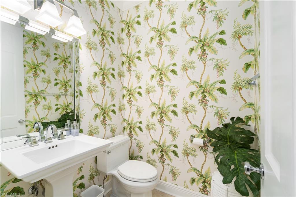 764 Ashburton Drive Naples, FL 34110 - Photo 26 of 30 a bathroom with a sink a toilet and shower curtain