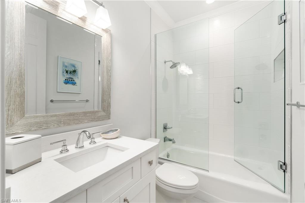 764 Ashburton Drive Naples, FL 34110 - Photo 28 of 30 a bathroom with a sink a toilet and shower