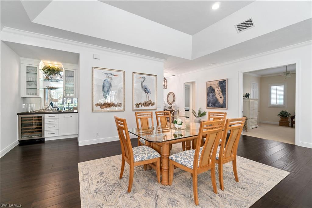 764 Ashburton Drive Naples, FL 34110 - Photo 7 of 30 a view of a dining room with furniture and wooden floor