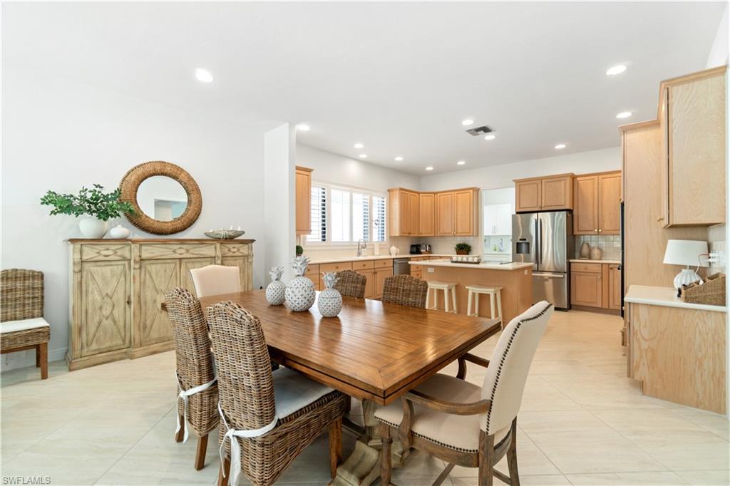 764 Ashburton Drive Naples, FL 34110 - Photo 9 of 30 a view of a dining room with furniture