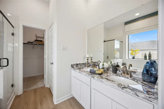 a bathroom with double vanity sink and mirror