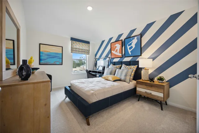 a bedroom with furniture and a painting on the wall