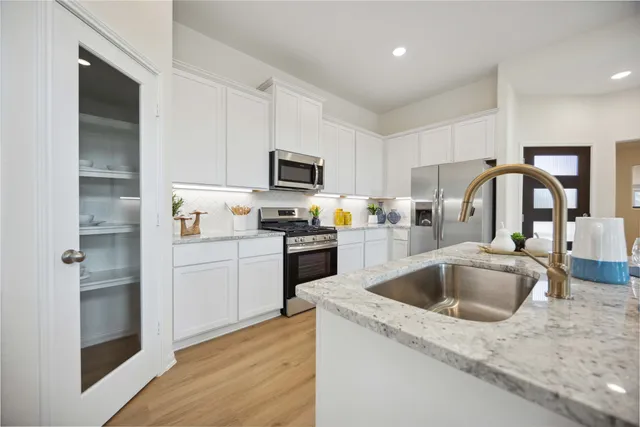 a kitchen with a refrigerator sink and stove