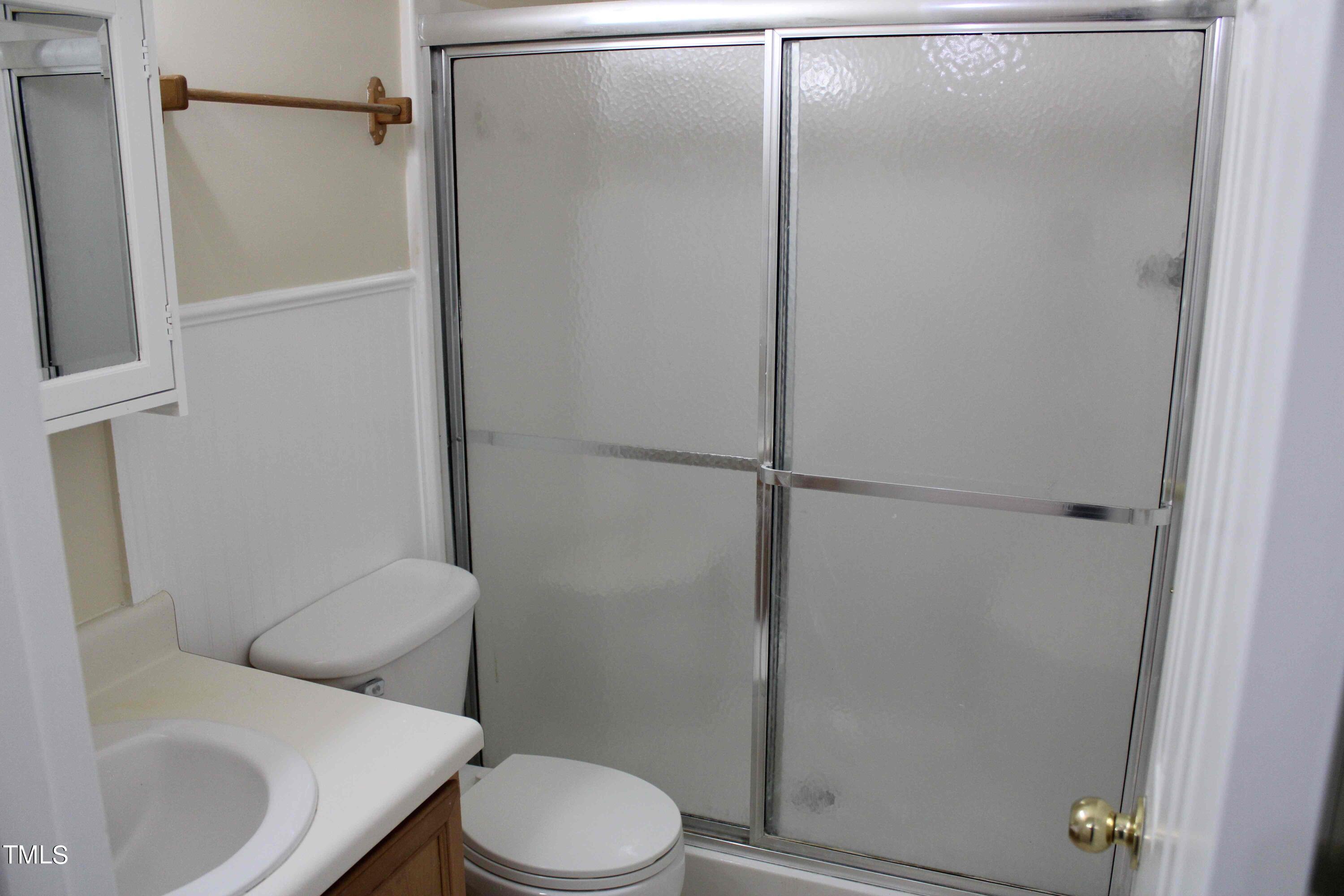 4426 Cottage Stone Drive Raleigh, NC 27616 - Photo 12 of 25 a white toilet sitting next to a bathroom sink