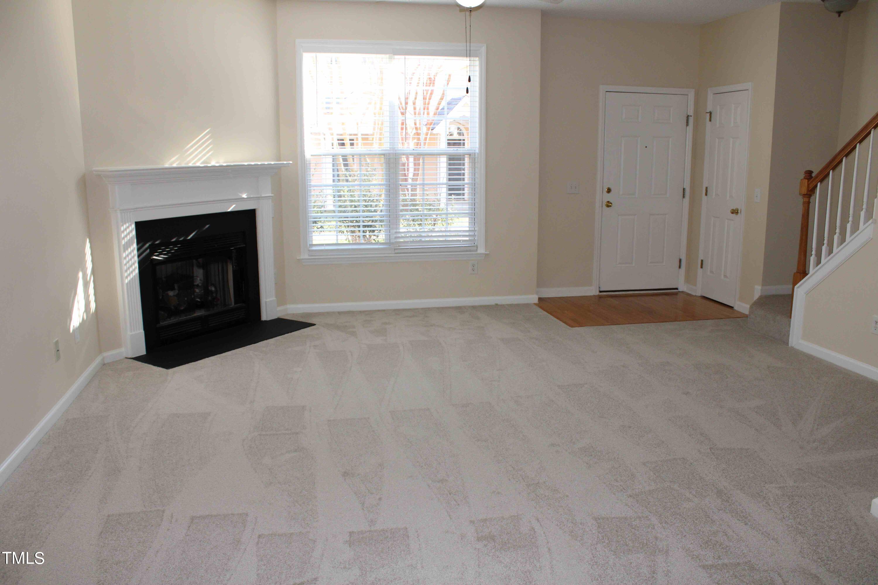 4426 Cottage Stone Drive Raleigh, NC 27616 - Photo 3 of 25 a view of an empty room with a fireplace and a window
