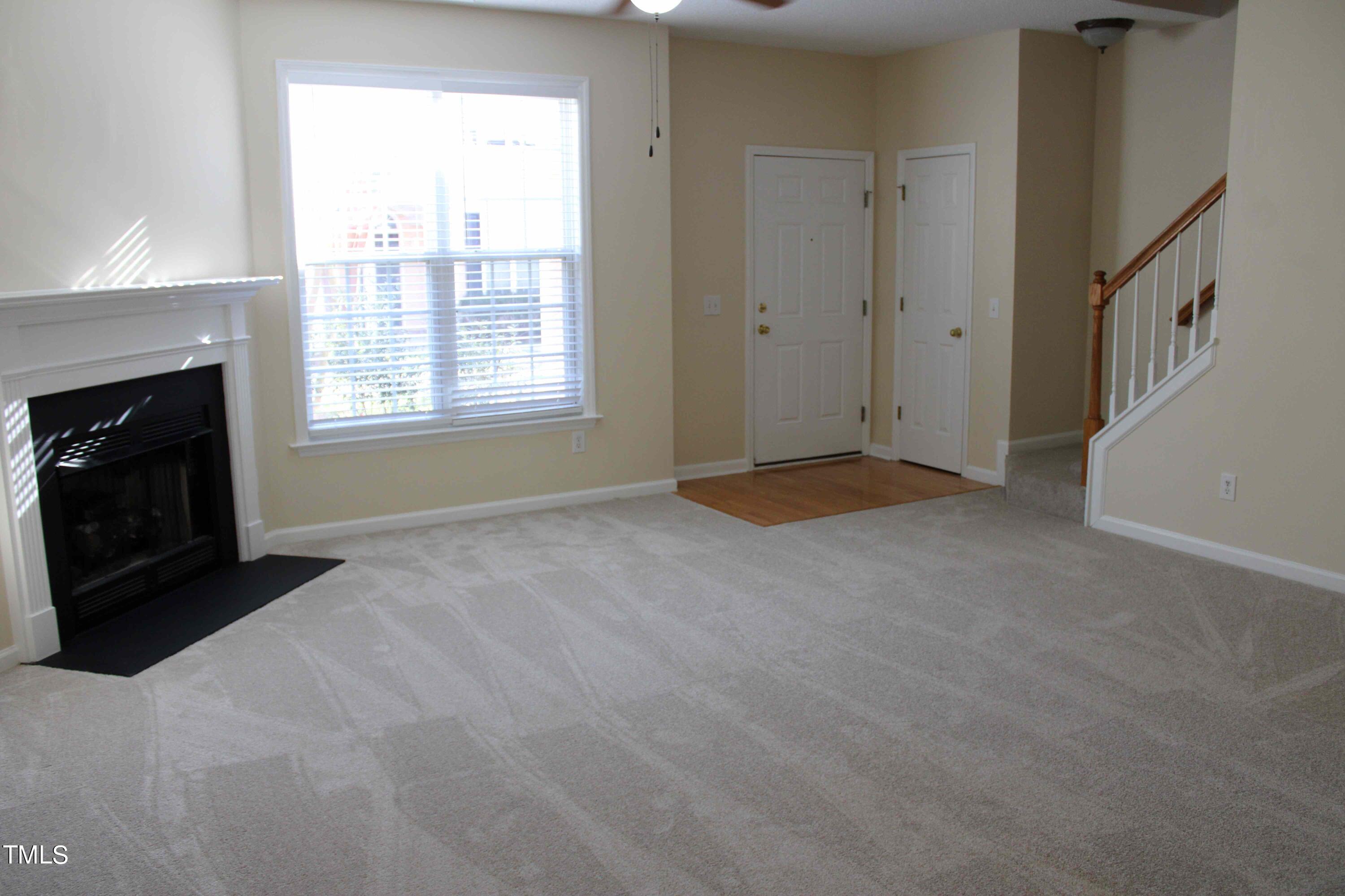 4426 Cottage Stone Drive Raleigh, NC 27616 - Photo 5 of 25 a view of an empty room with a fireplace and a window
