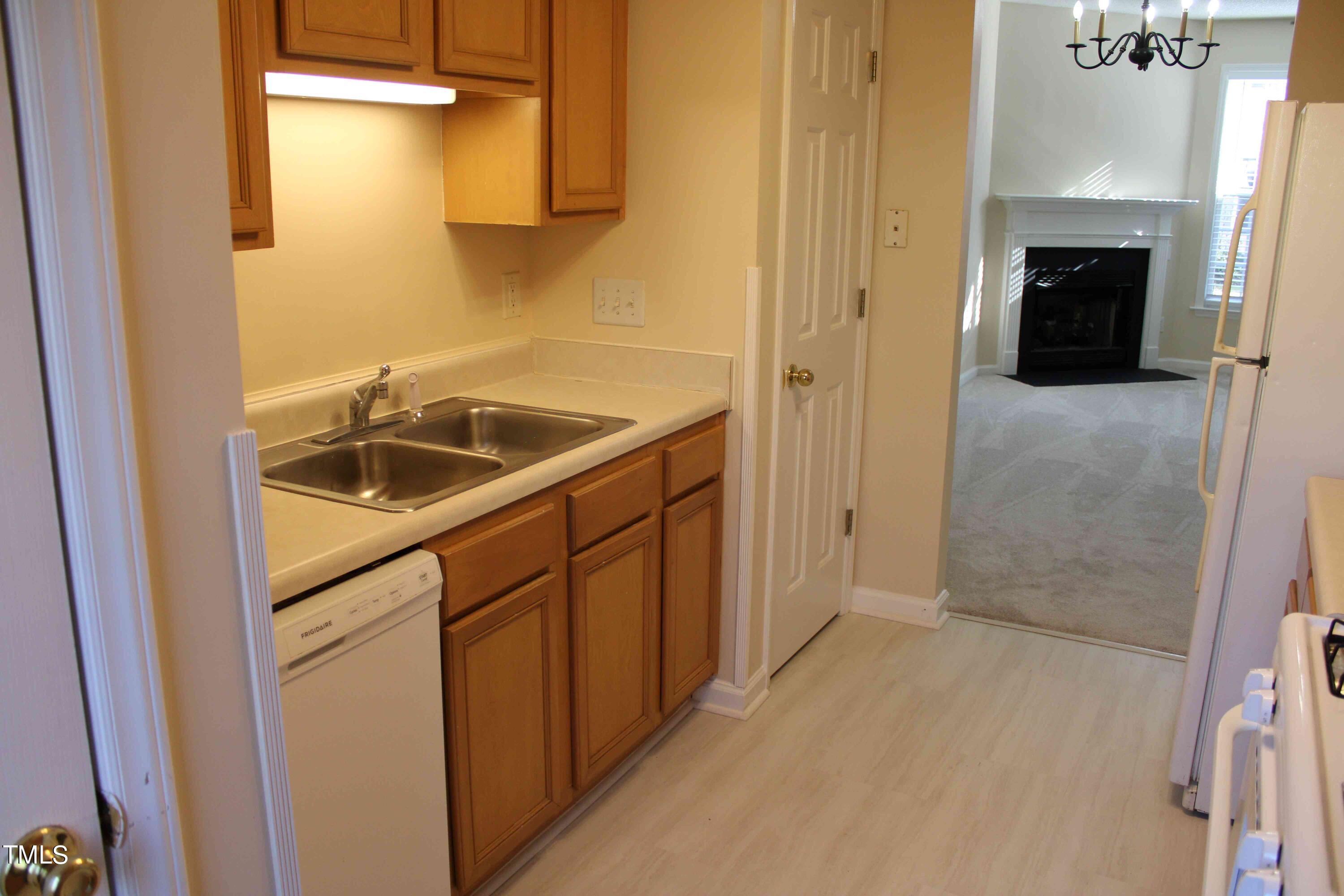 4426 Cottage Stone Drive Raleigh, NC 27616 - Photo 8 of 25 a kitchen with a sink and refrigerator