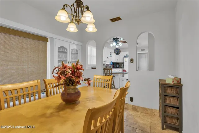 a view of a dining room with furniture and chandelier