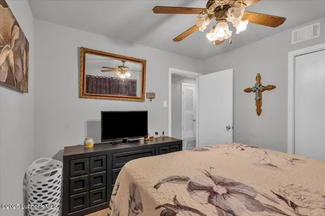 a bedroom with a bed and a tv