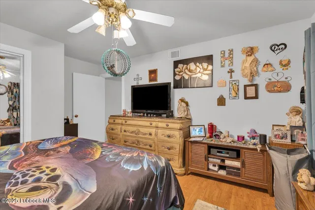 a bed room with a bed and a television