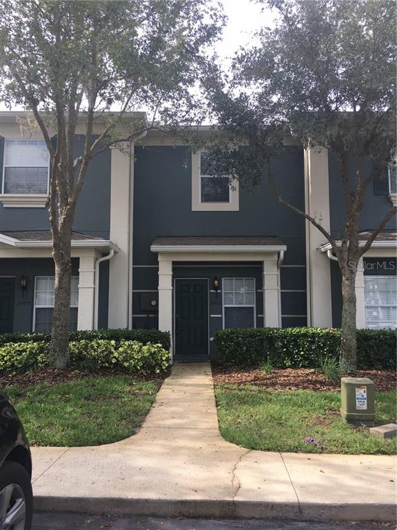 10466 Manderley Way, Unit 89 Orlando, FL 32829 - Photo 1 of 1 a front view of a house with a yard and garage