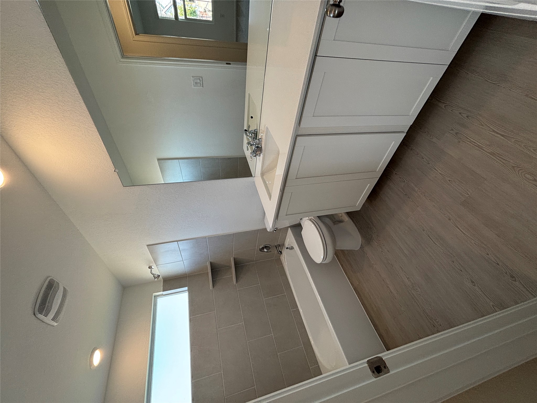3262 Everett Kyle, TX 78640 - Photo 3 of 24 Full bath featuring bathing tub / shower combination, vanity, light wood finished floors, a textured wall, and recessed lighting