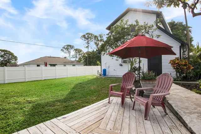 a view of a deck with furniture and a yard