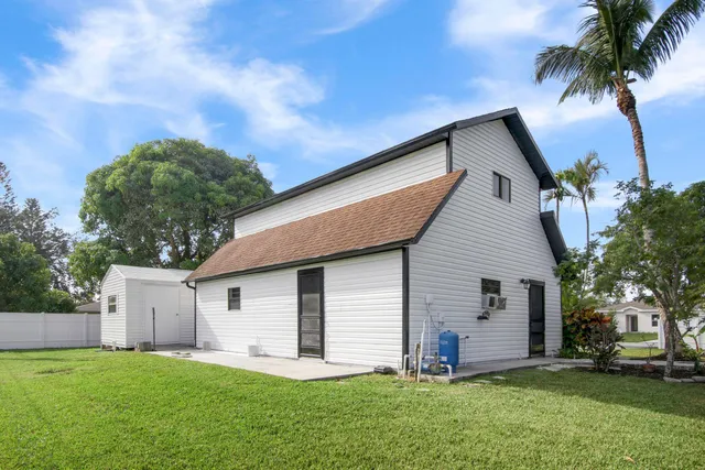 a front view of house with yard and trees