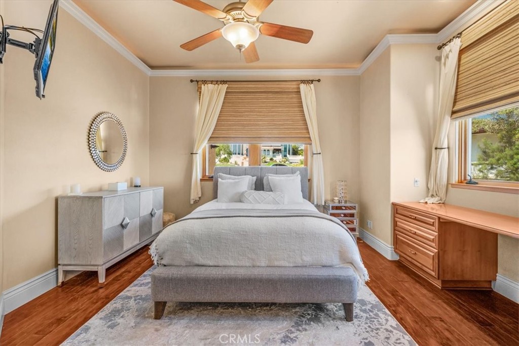 413 Via Bandolero Arroyo Grande, CA 93420 - Photo 21 of 75 a spacious bedroom with a bed a chandelier and dresser