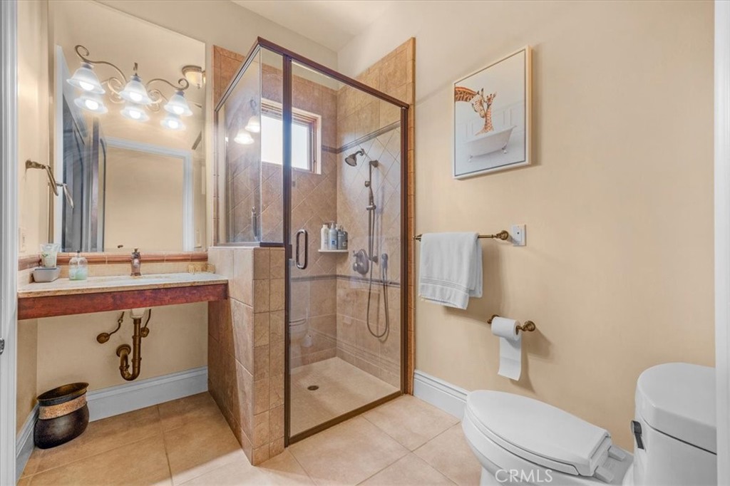 413 Via Bandolero Arroyo Grande, CA 93420 - Photo 27 of 75 a bathroom with a double vanity sink toilet and shower