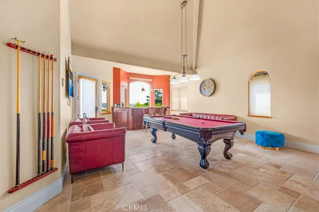 a kitchen with cabinets a counter and chairs
