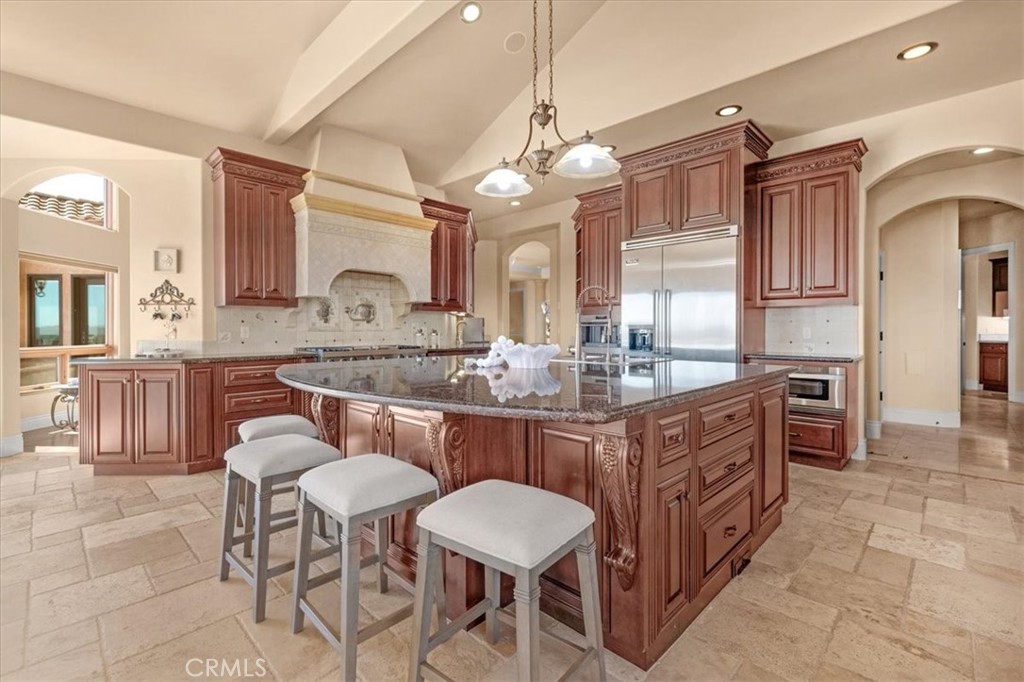 413 Via Bandolero Arroyo Grande, CA 93420 - Photo 35 of 75 a kitchen with cabinets a counter and chairs