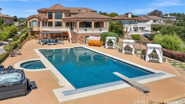 a view of a house with large windows and a small yard