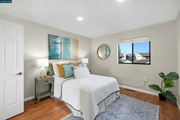 a bedroom with a bed and a painting on the wall