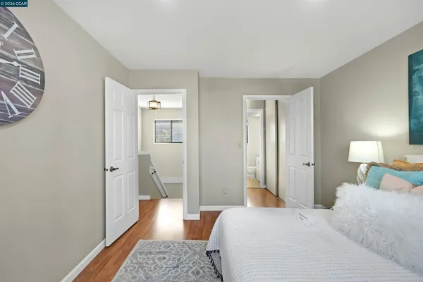 a bedroom with a bed and wooden floor