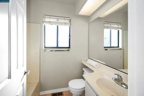 a white toilet sitting next to a bathroom sink