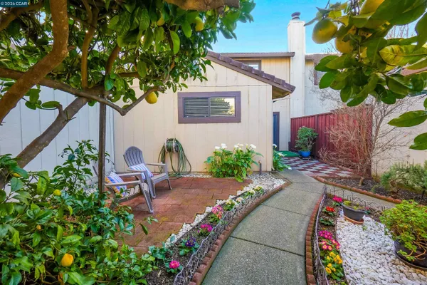 a backyard of a house with outdoor seating