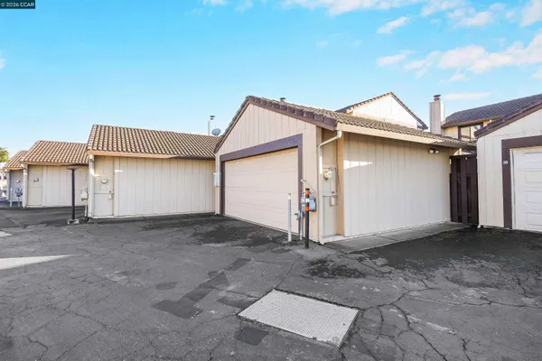 a view of a house with a yard and garage