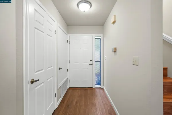 a view of a hallway with wooden floor