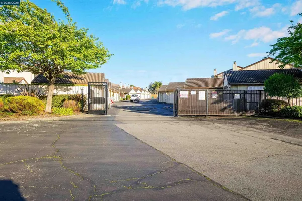 a street view with residential house and car parked on street side