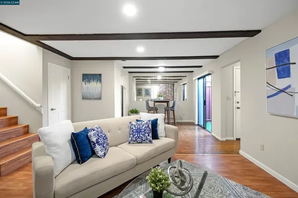 a living room with furniture and a wooden floor