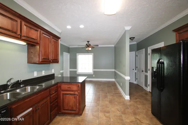 a kitchen with stainless steel appliances granite countertop a refrigerator and a sink