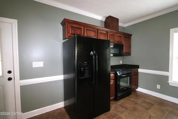 a kitchen with stainless steel appliances granite countertop a refrigerator and a stove