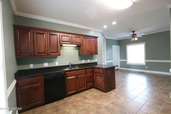 a kitchen with stainless steel appliances granite countertop a sink and cabinets