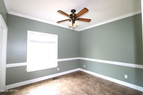 a view of room with window and ceiling fan