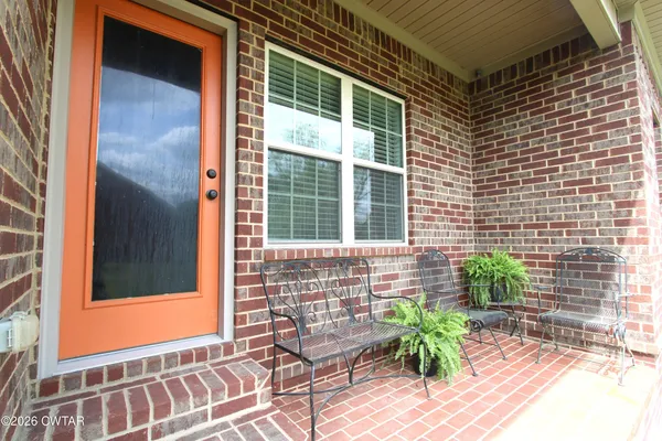 a view of house with backyard