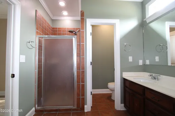 a bathroom with a double vanity sink toilet and shower