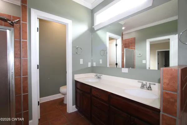 an empty room with a window and a ceiling fan
