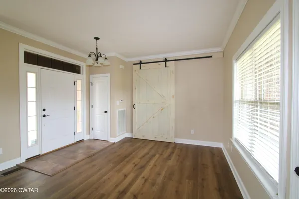 a view of a room with wooden floor closet and windows